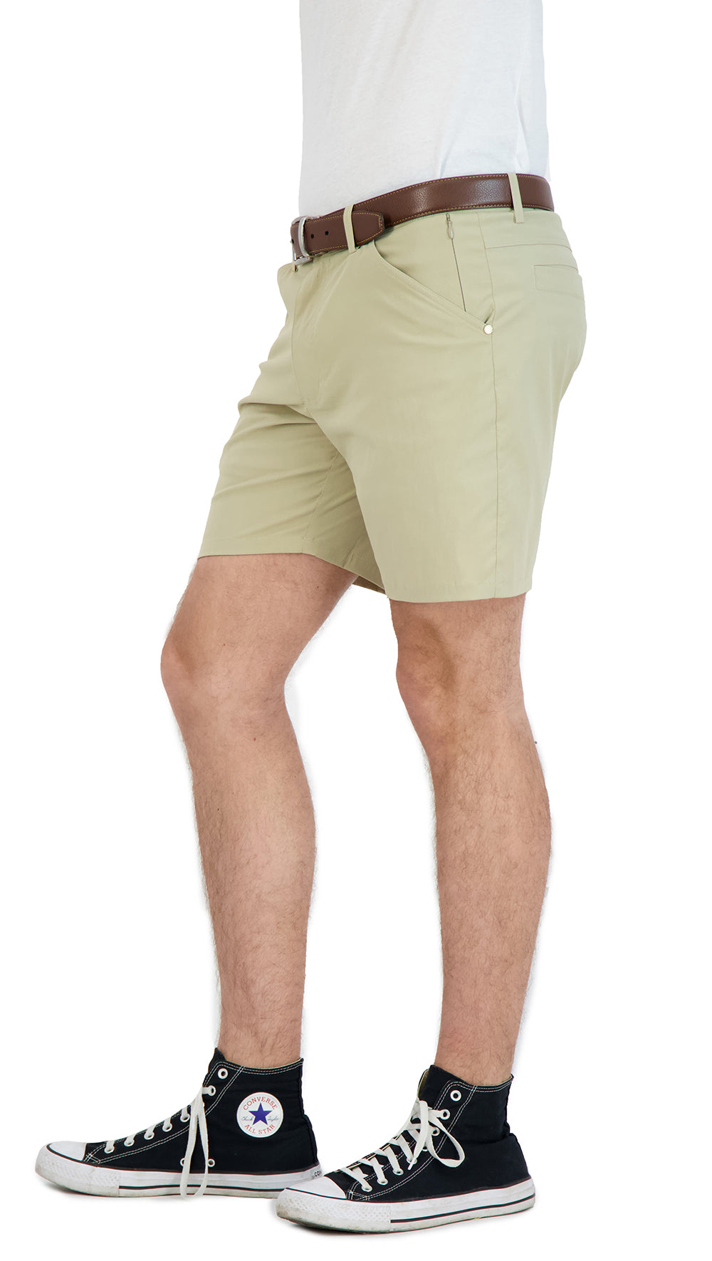 Person wearing light green shorts with a white shirt and black sneakers on a white background