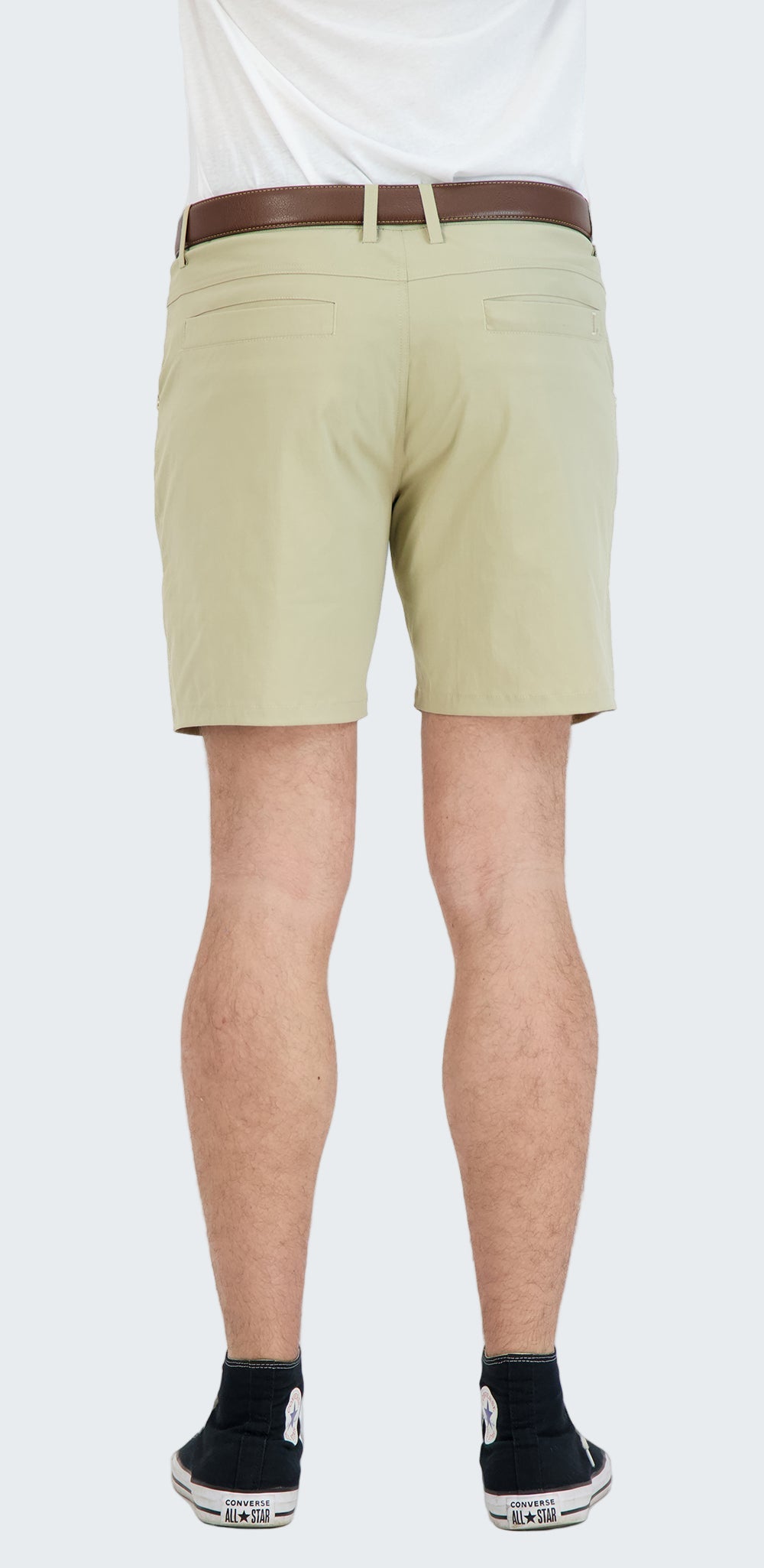 Beige shorts worn by a person on a white background
