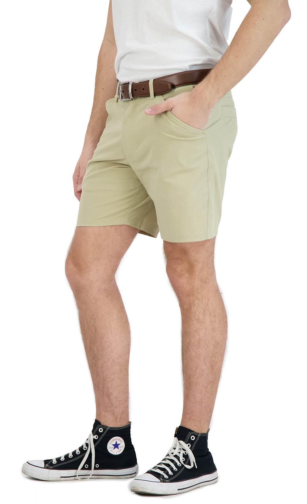 Person wearing light green shorts and black sneakers on a white background