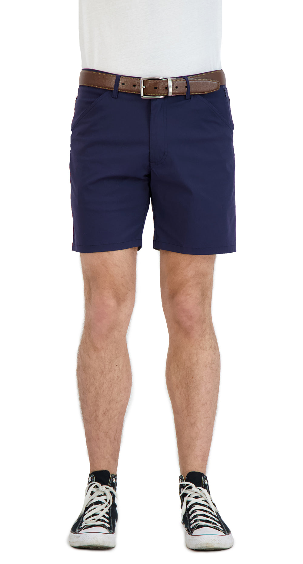 Person wearing navy shorts with a brown belt on a white background