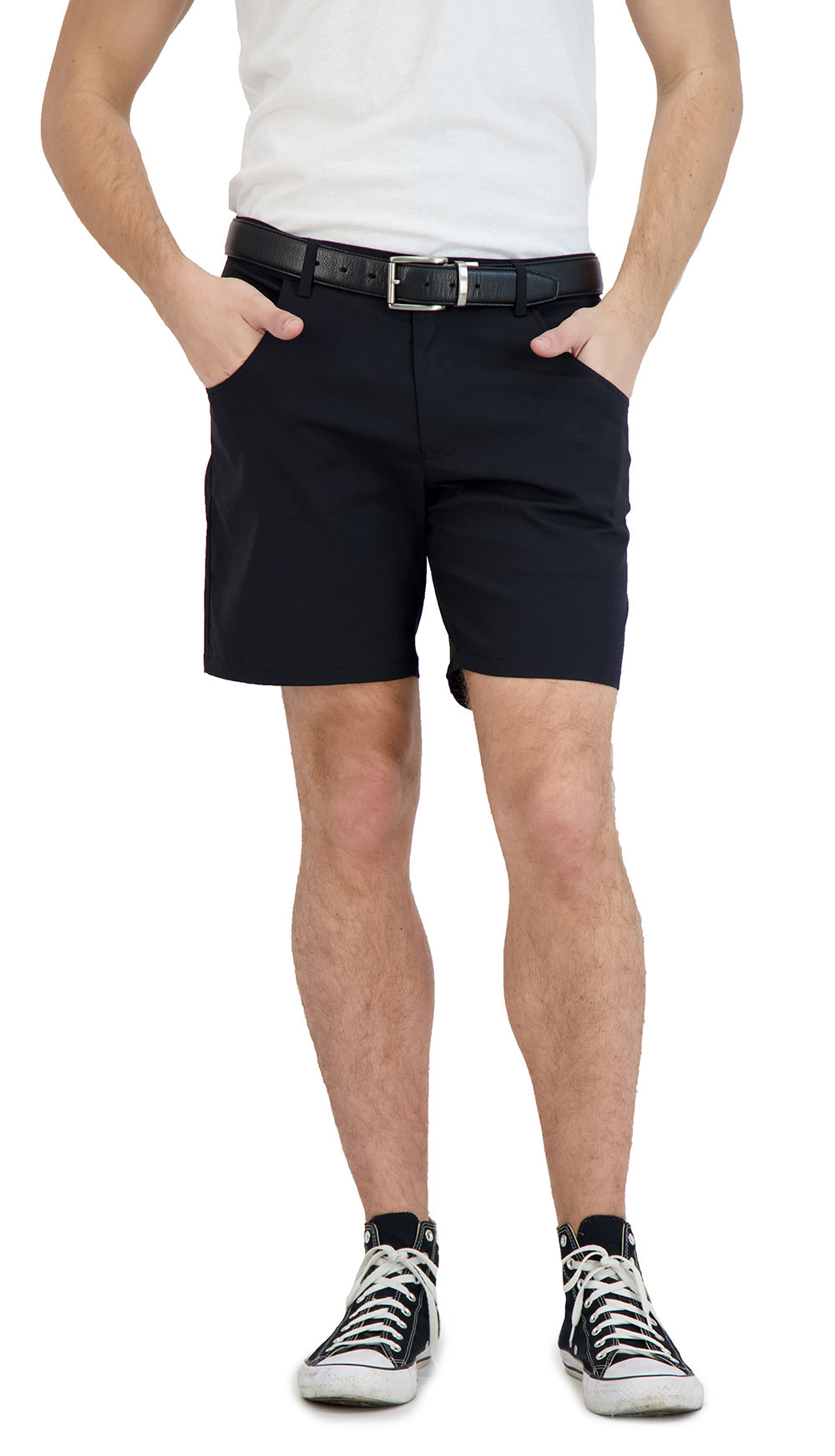 Person wearing black shorts and white sneakers on a white background
