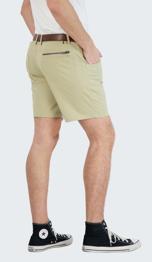 Beige shorts worn by a person on a white background