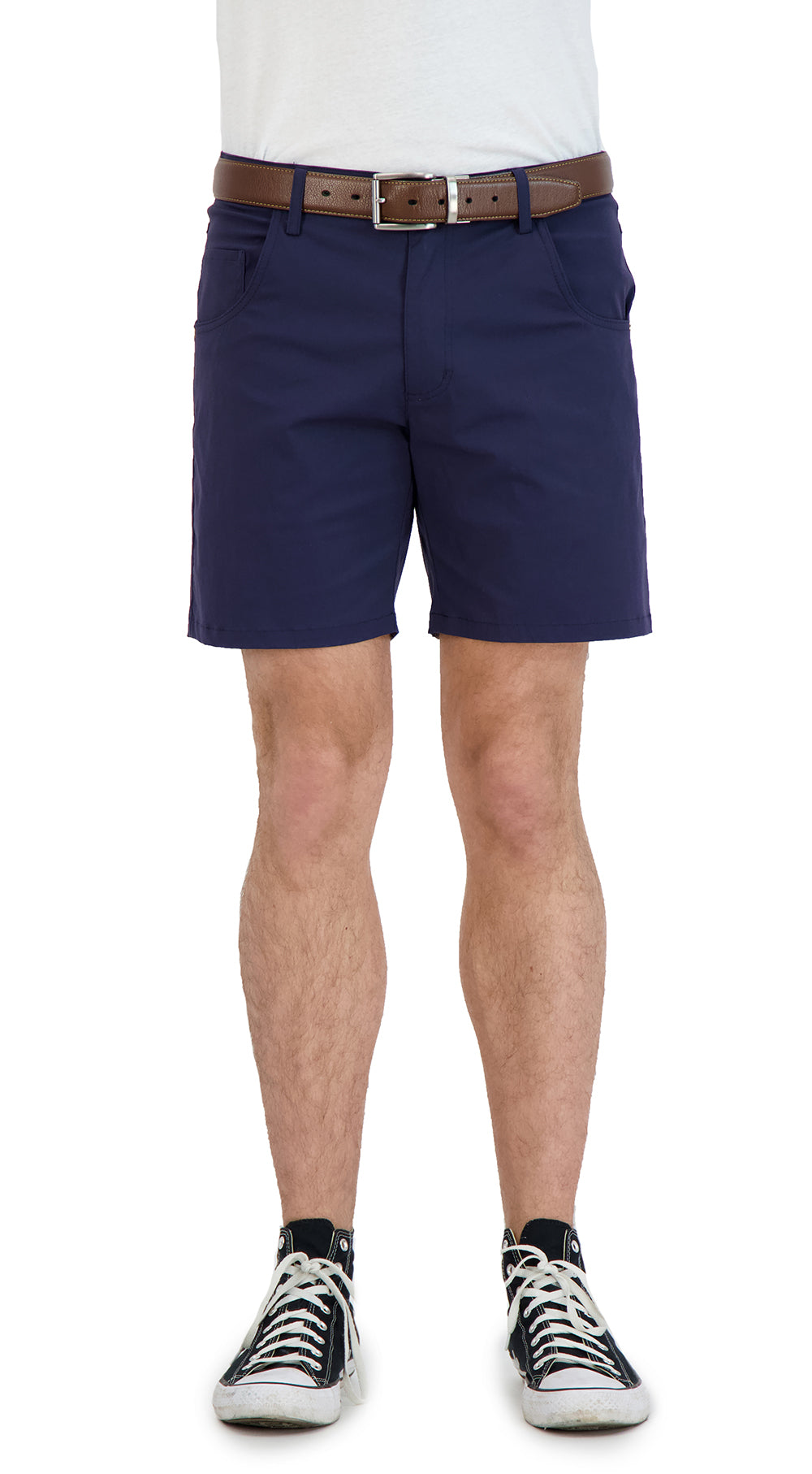 Person wearing navy shorts with a white background
