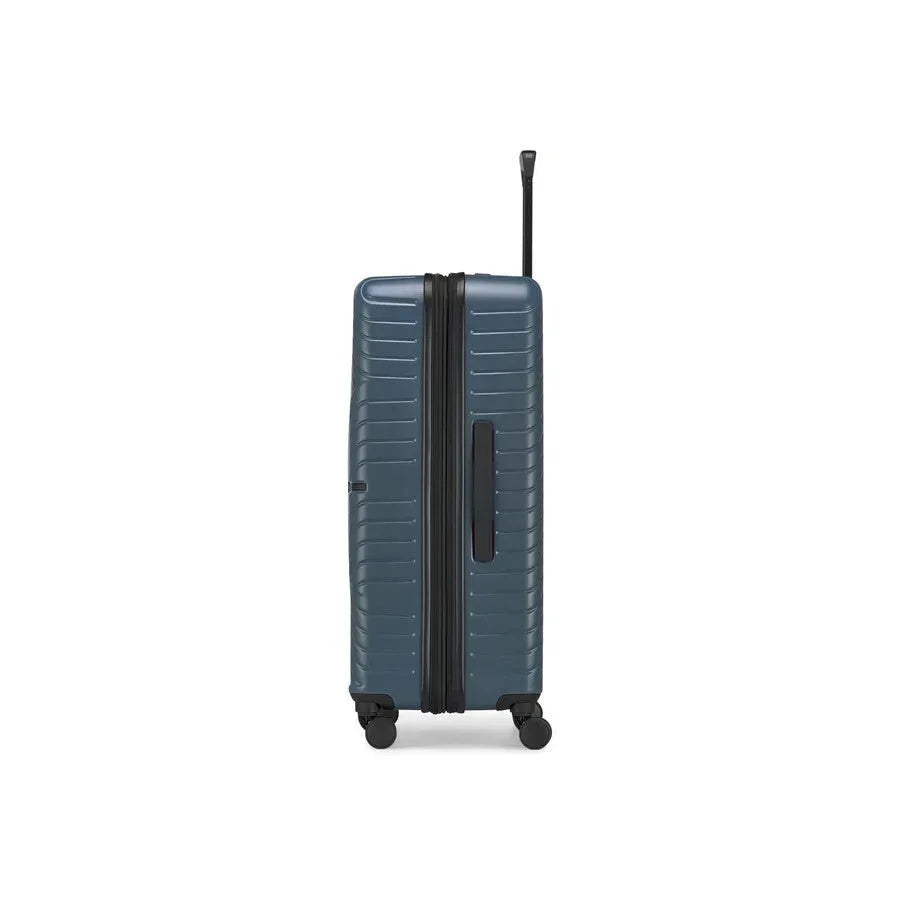 Blue suitcase with a black handle on a white background
