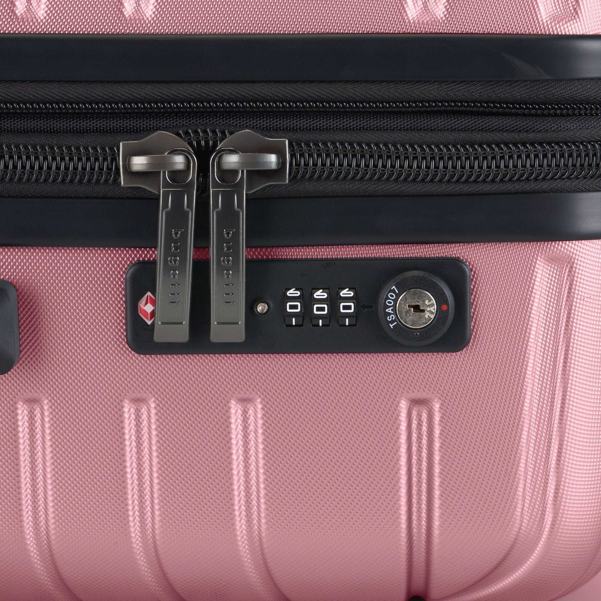 Close-up of a pink suitcase with a lock mechanism