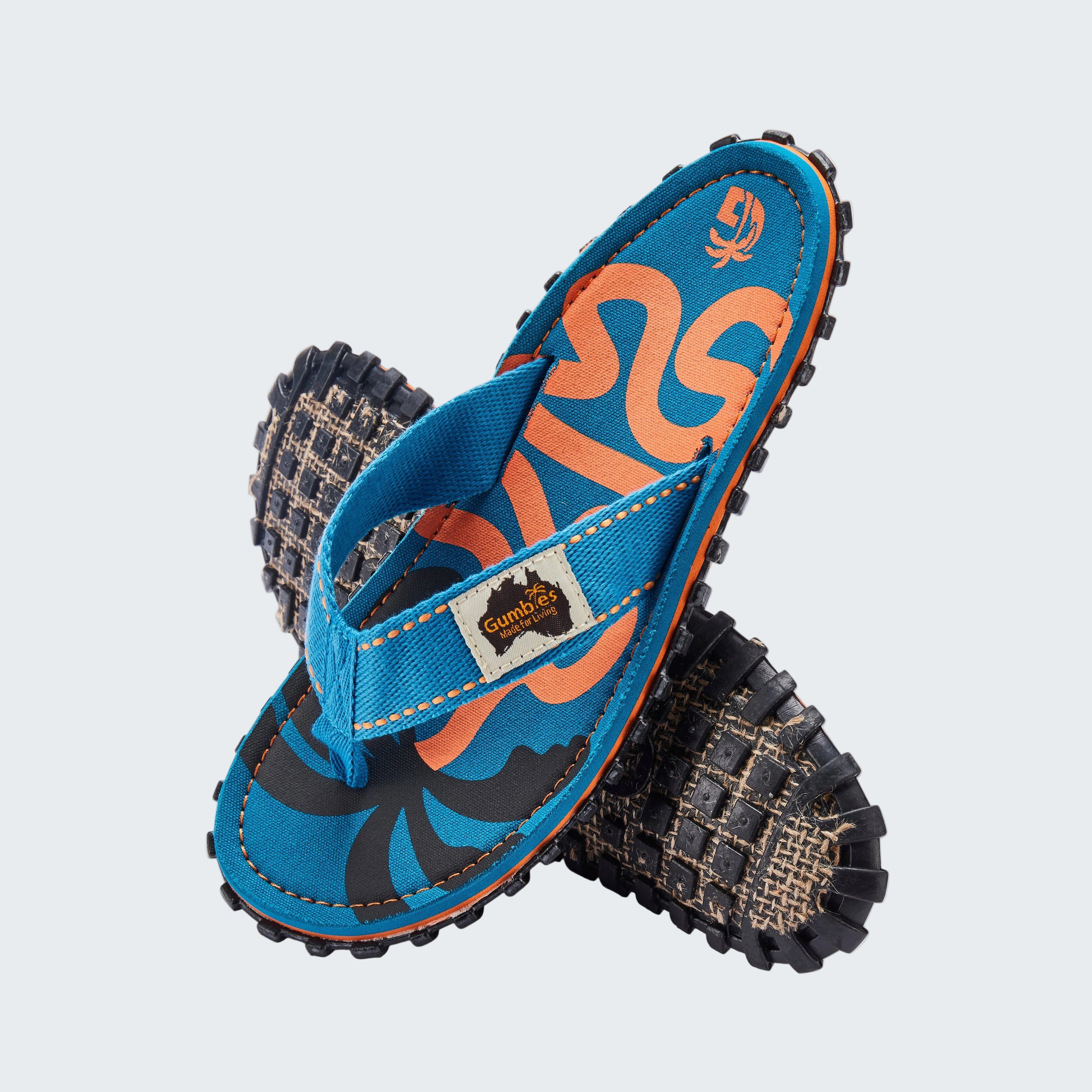 Blue and orange sandals with textured soles on a white background