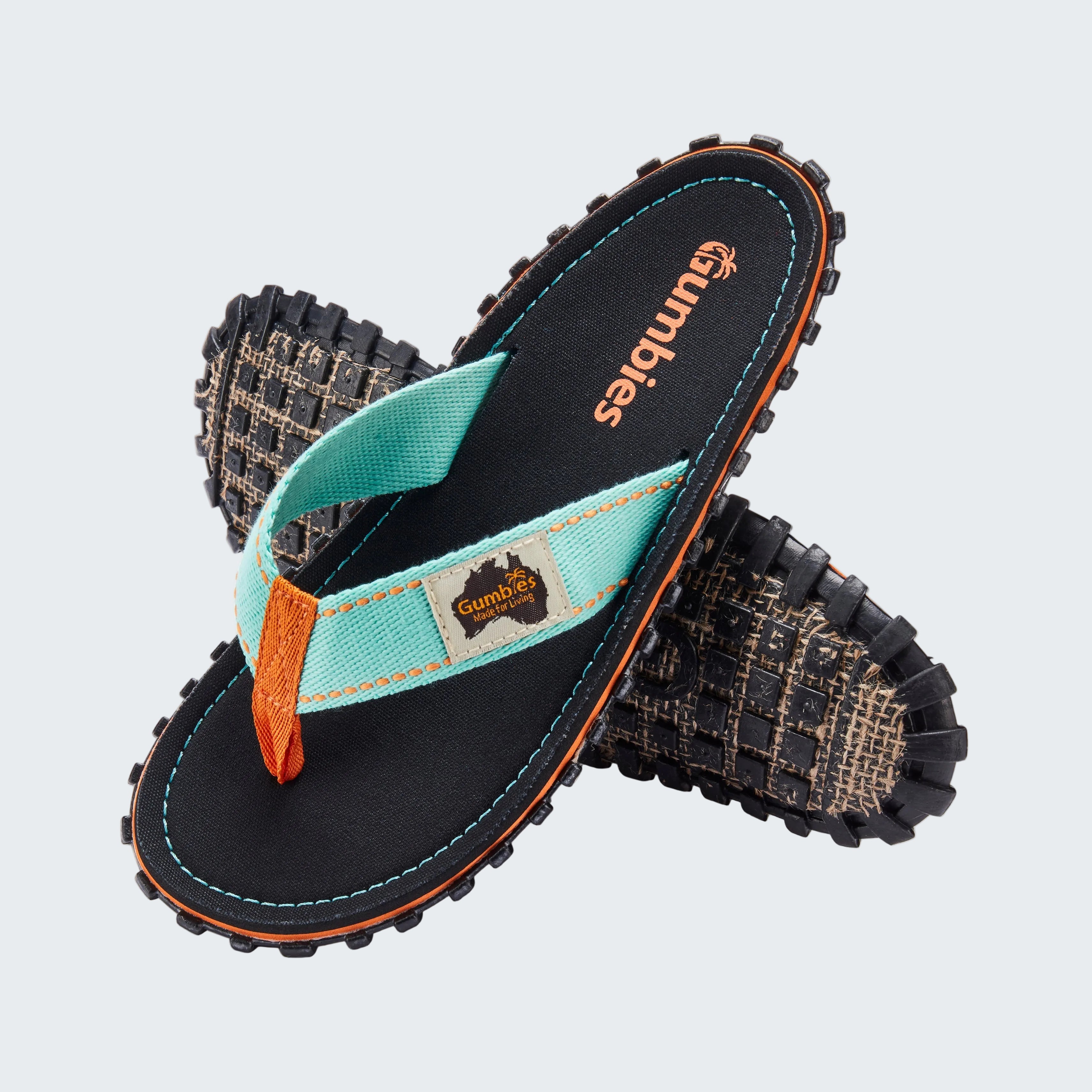 Pair of black sandals with a turquoise strap on a white background