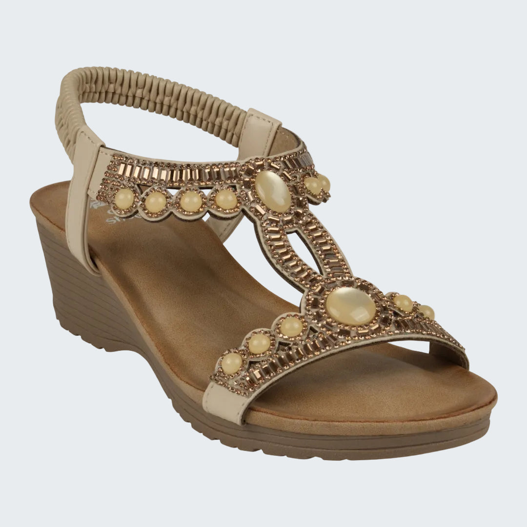Beige sandal with decorative elements on a white background