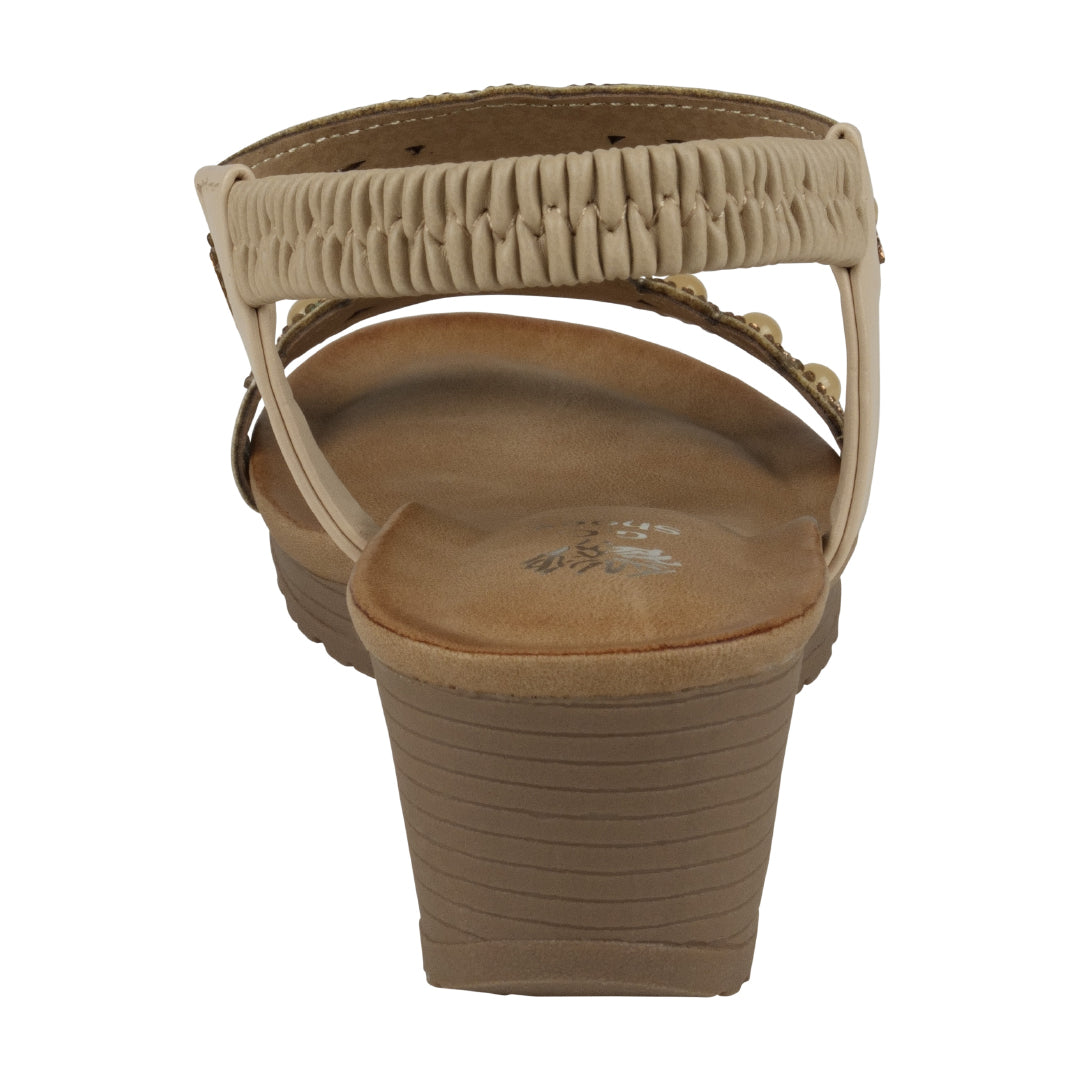 Beige sandal with wedge sole on a white background