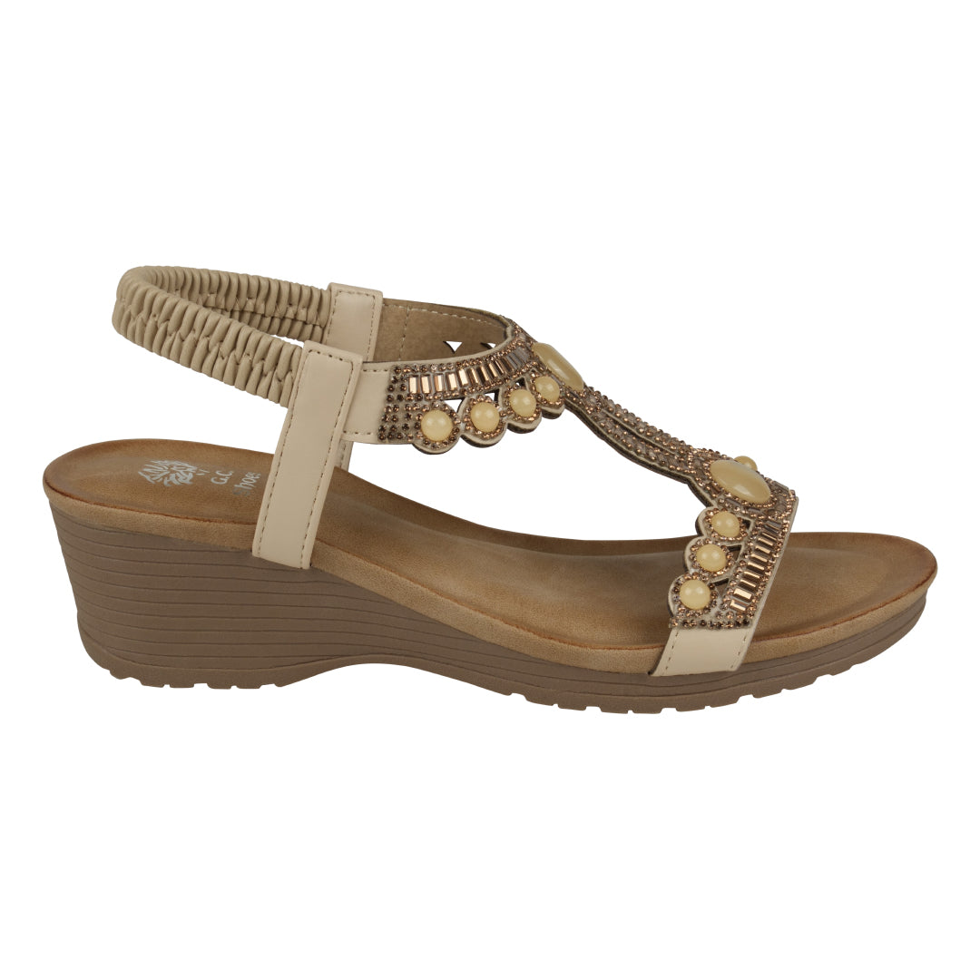 Brown sandal with decorative elements on a white background