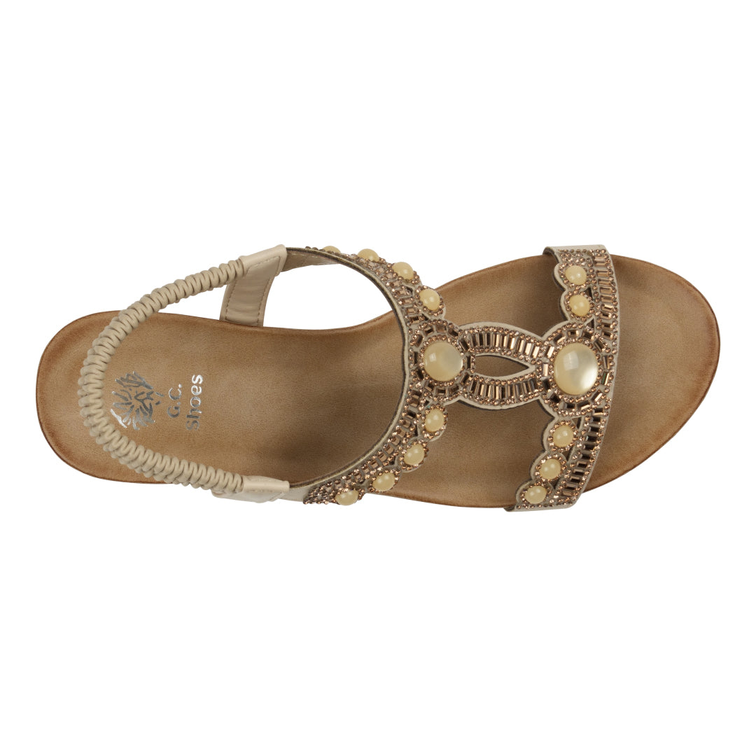 Brown sandal with decorative elements on a white background