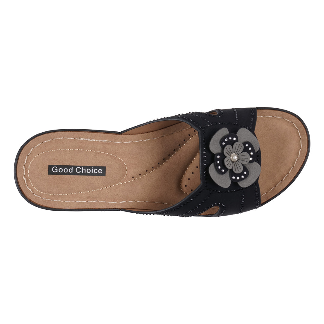 Black sandal with a floral design on a white background