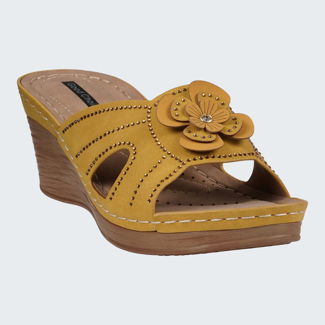 Yellow wedge sandal with floral design on a white background