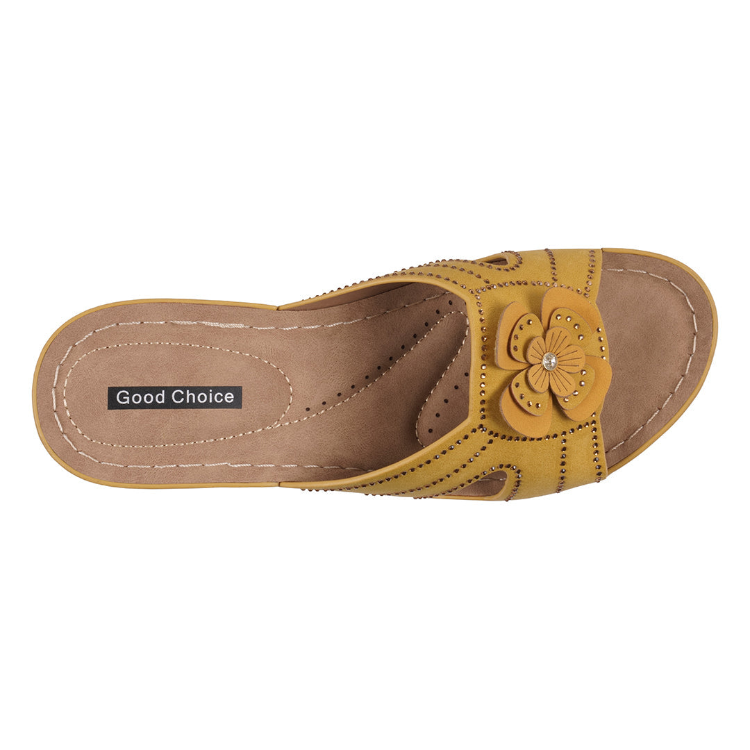 Yellow sandal with a flower detail on a white background