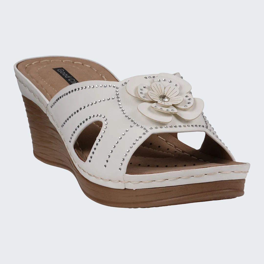 White sandal with a flower design on a white background