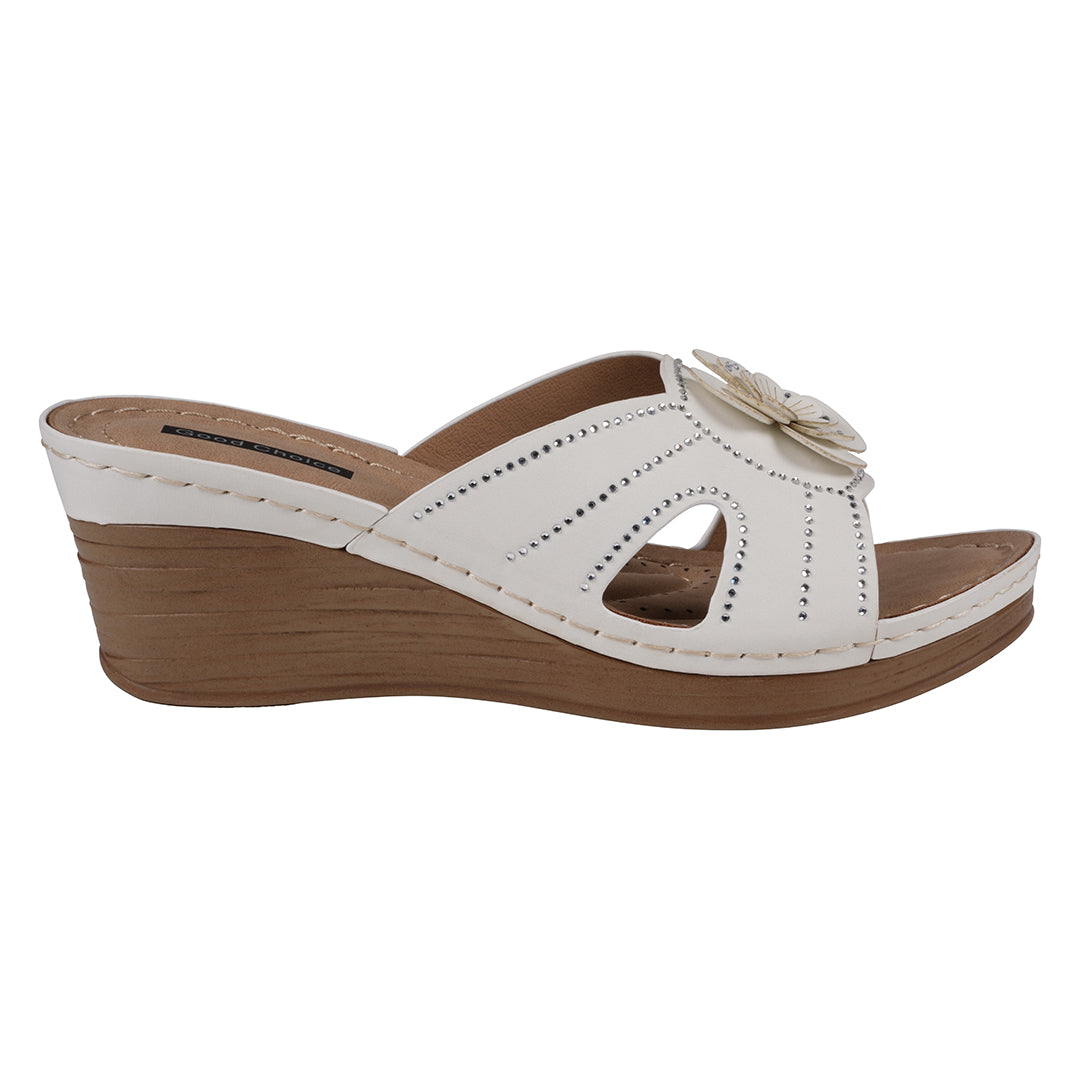 White wedge sandal with a wooden sole on a white background