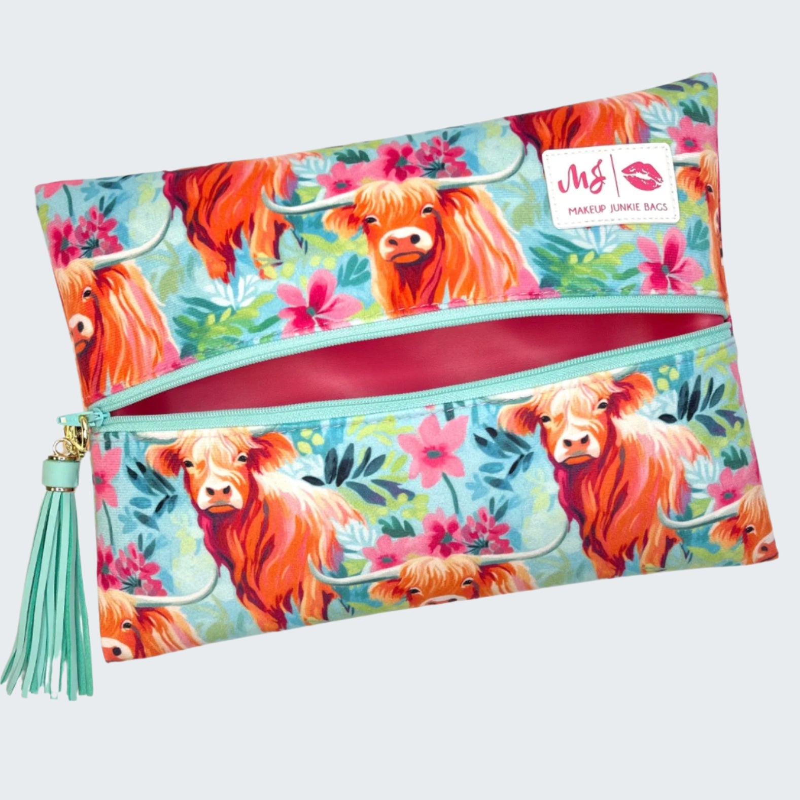 Floral pouch with highland cow design and tassel on a white background