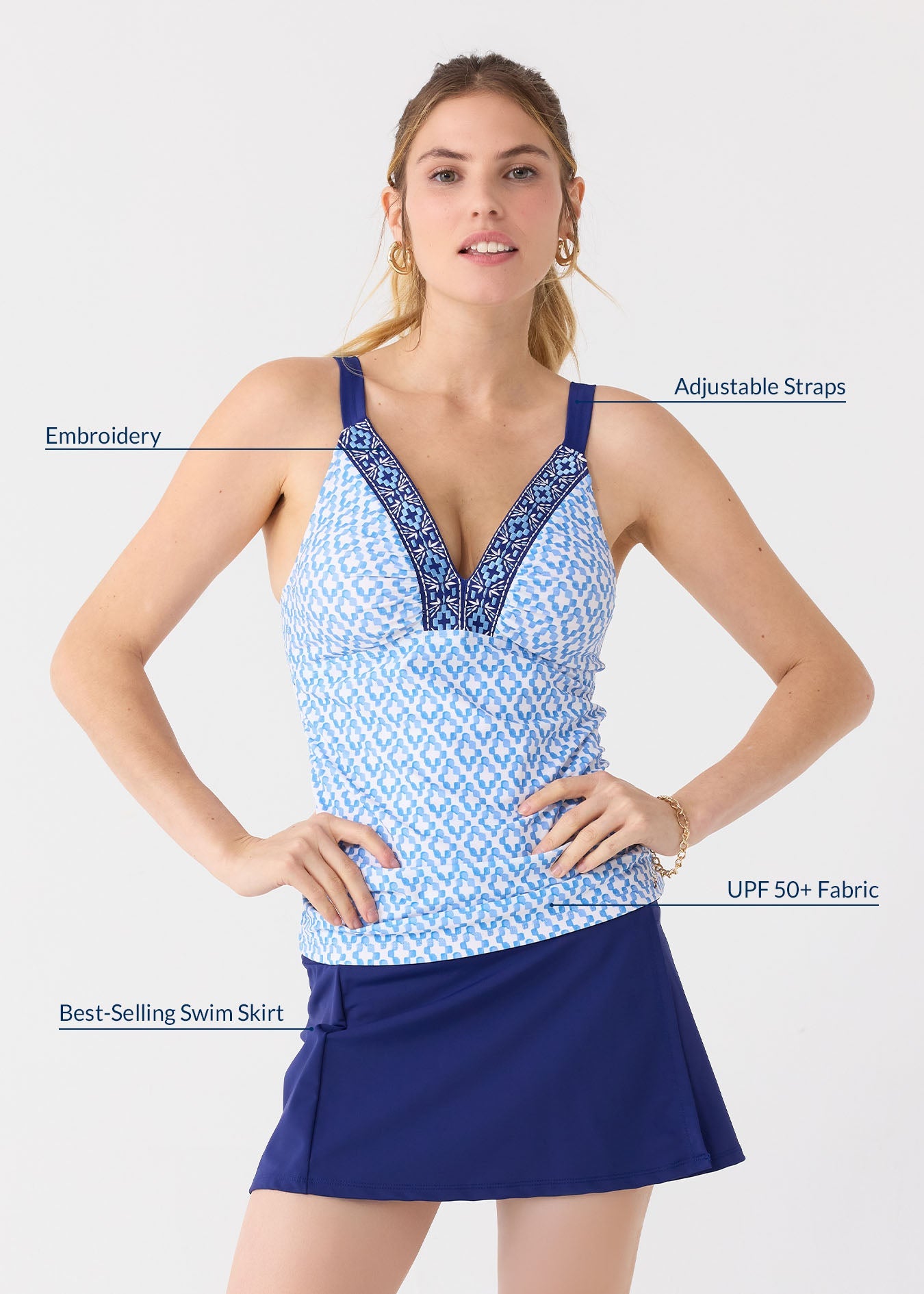 Woman wearing a blue and white patterned top with adjustable straps and a matching skirt, on a light gray background.