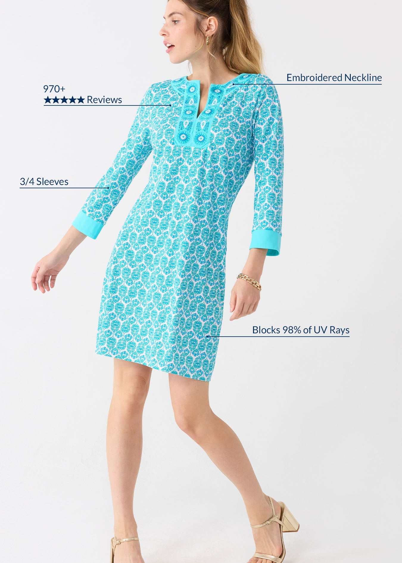 Woman wearing a turquoise dress with floral pattern on a white background