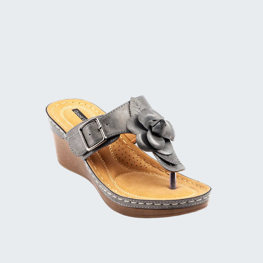 Gray wedge sandal with a floral design on a white background
