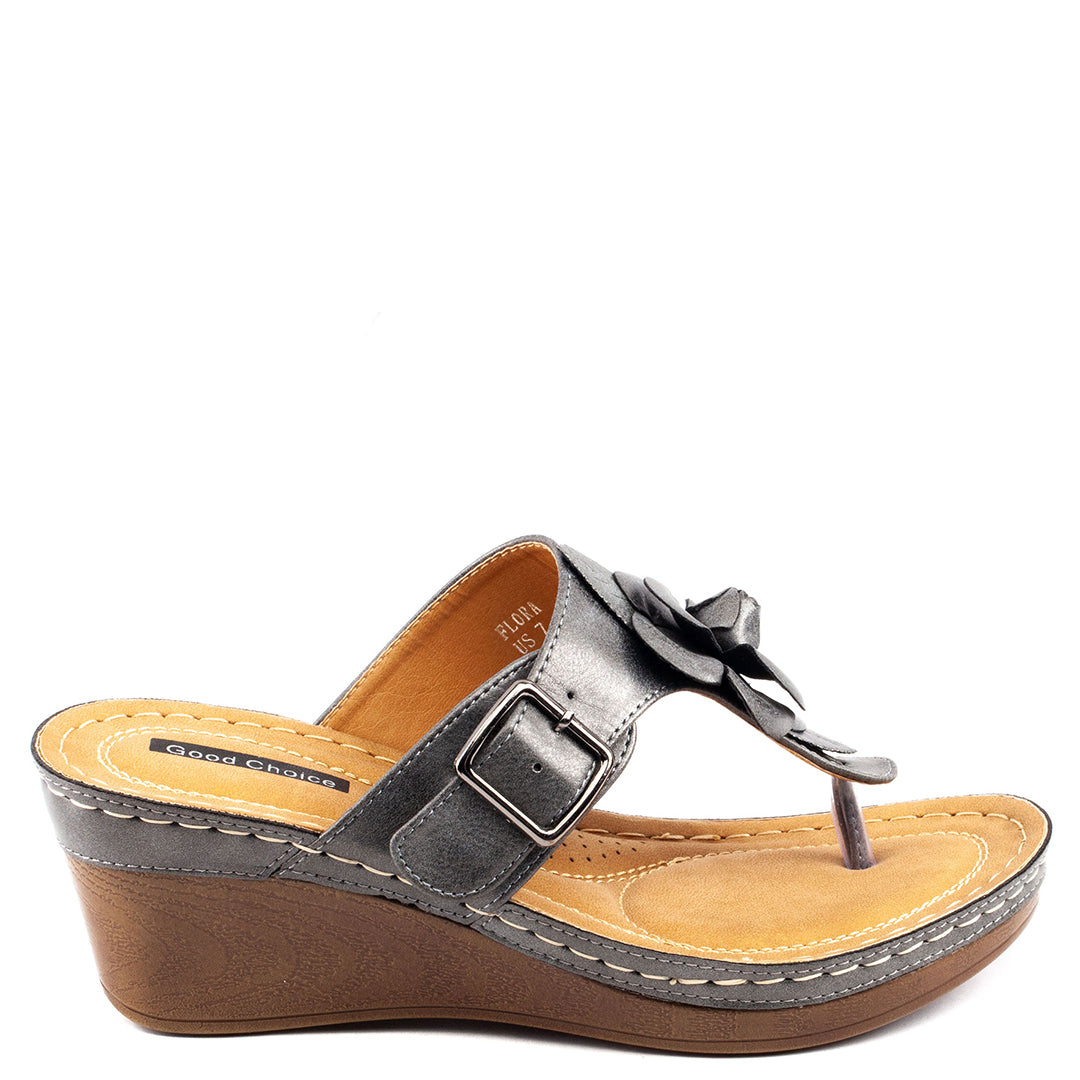 Silver wedge sandal with a brown sole on a white background