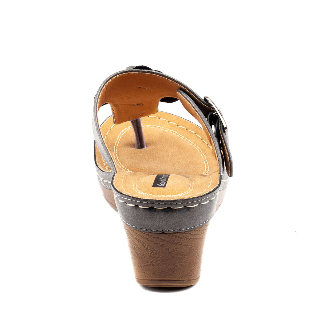 Brown sandal with a wedge heel on a white background