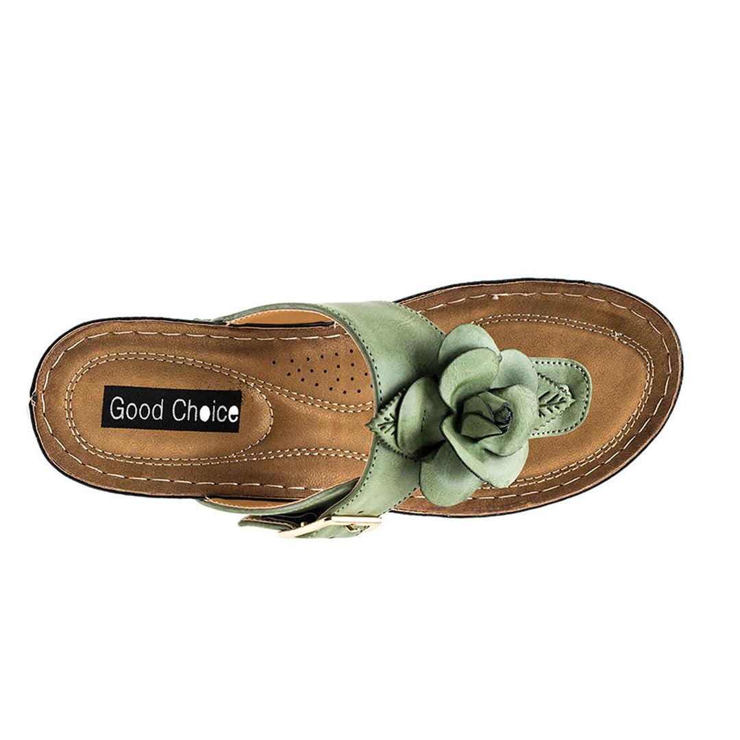Sandal with a green flower detail on a white background