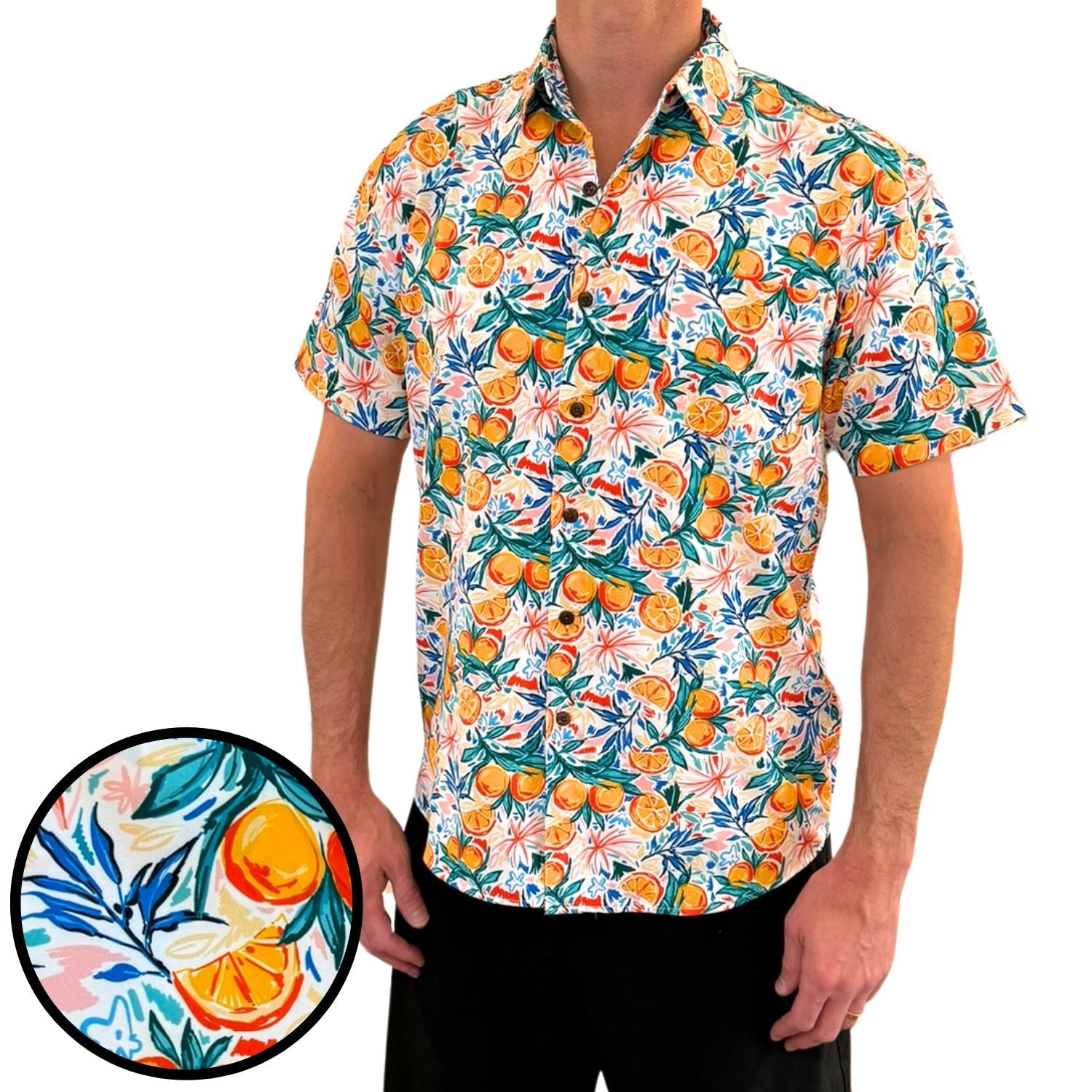 Person wearing a colorful shirt with fruit pattern on a white background