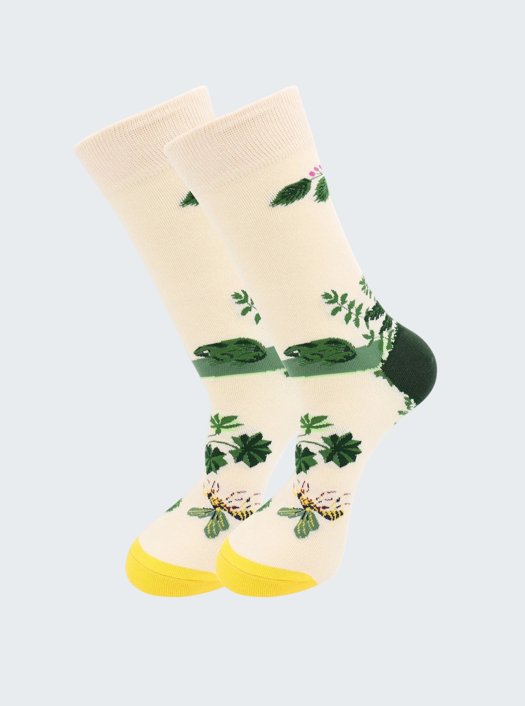 Beige socks with green leaf patterns on a white background