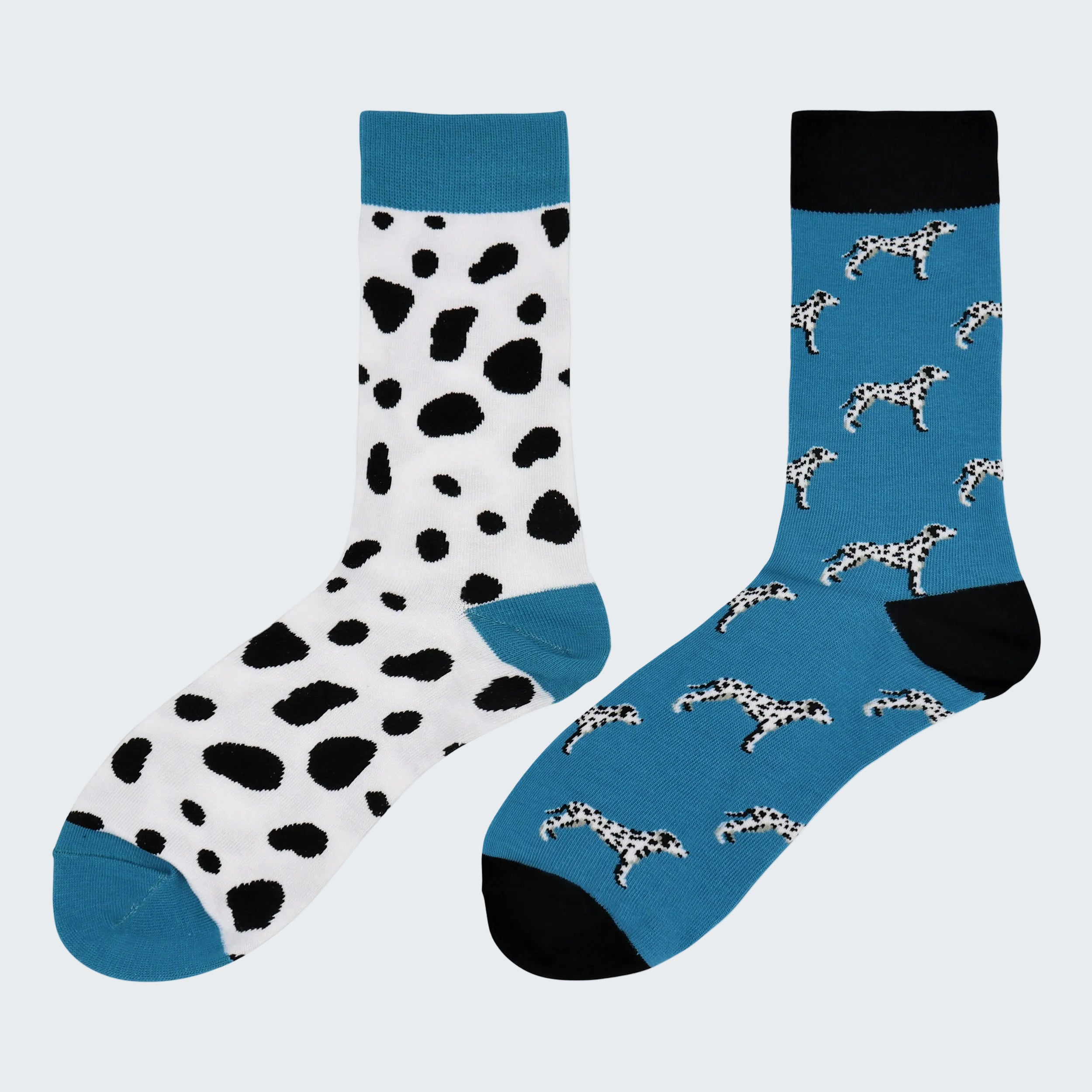 Two pairs of socks with dalmatian pattern on a white background
