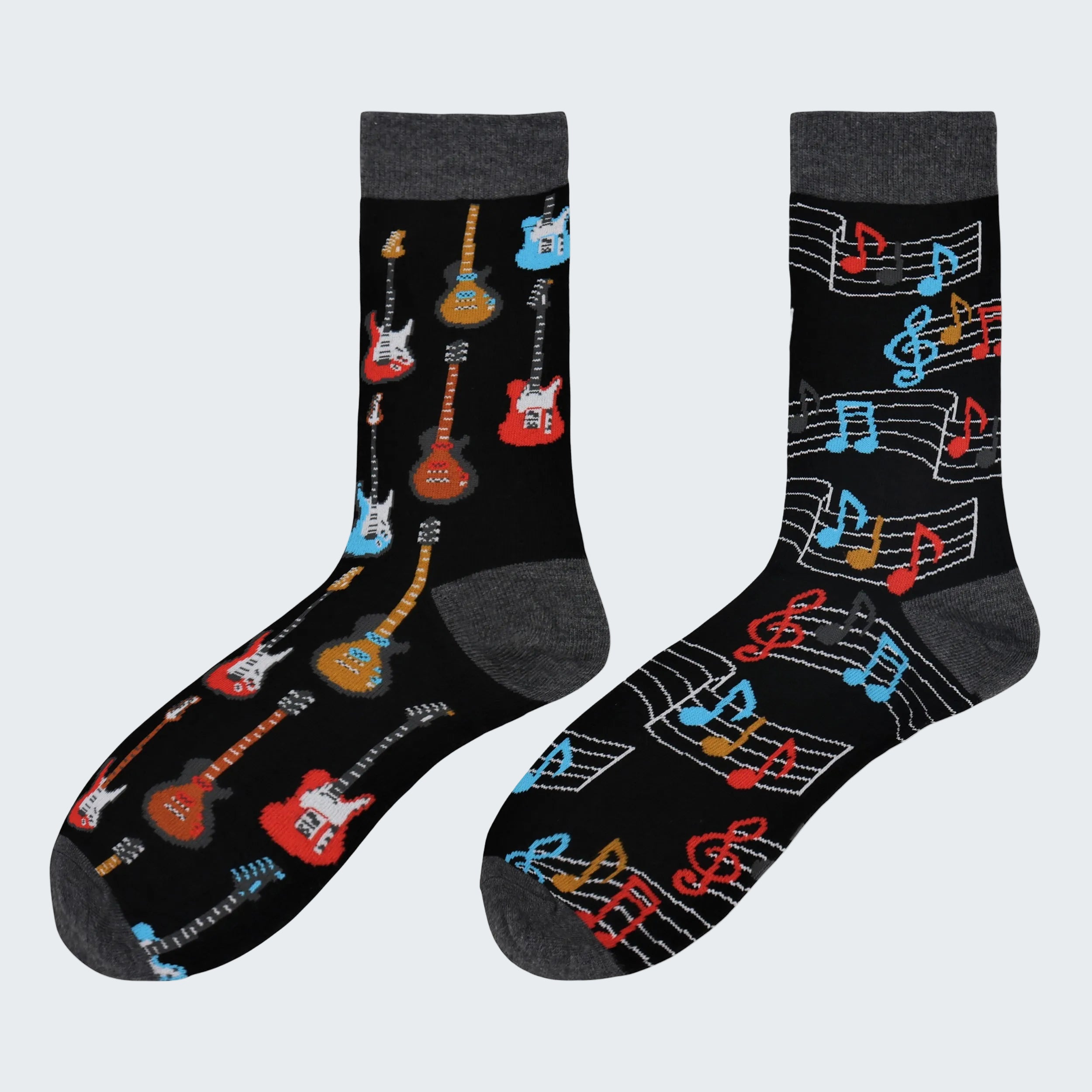 Two pairs of socks with guitar and music note designs on a white background