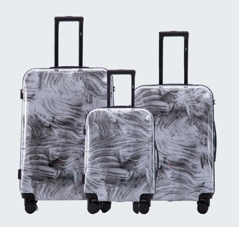 Set of three gray marbled suitcases with wheels on a white background