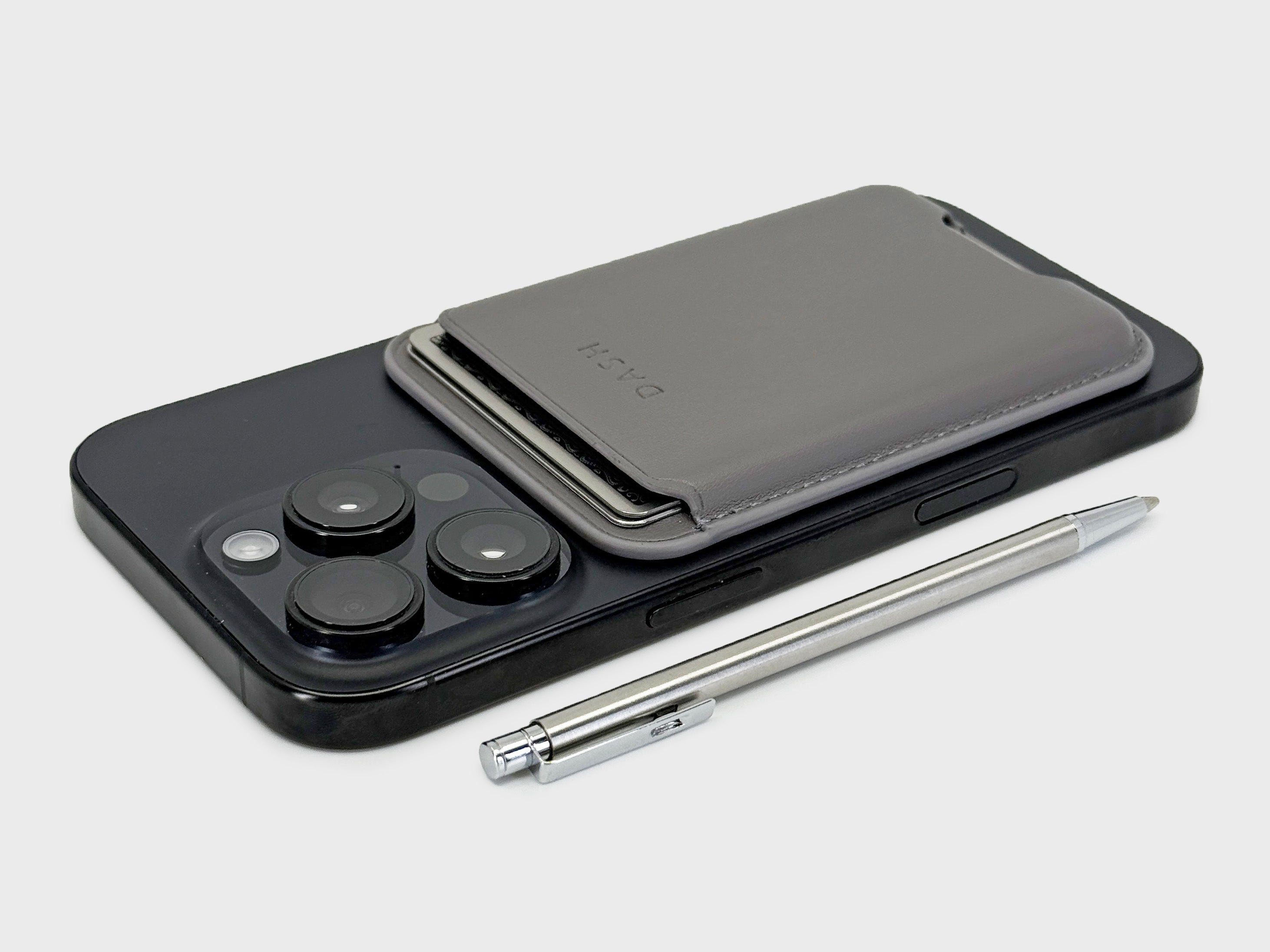 Smartphone with a black case and silver stylus on a light gray background