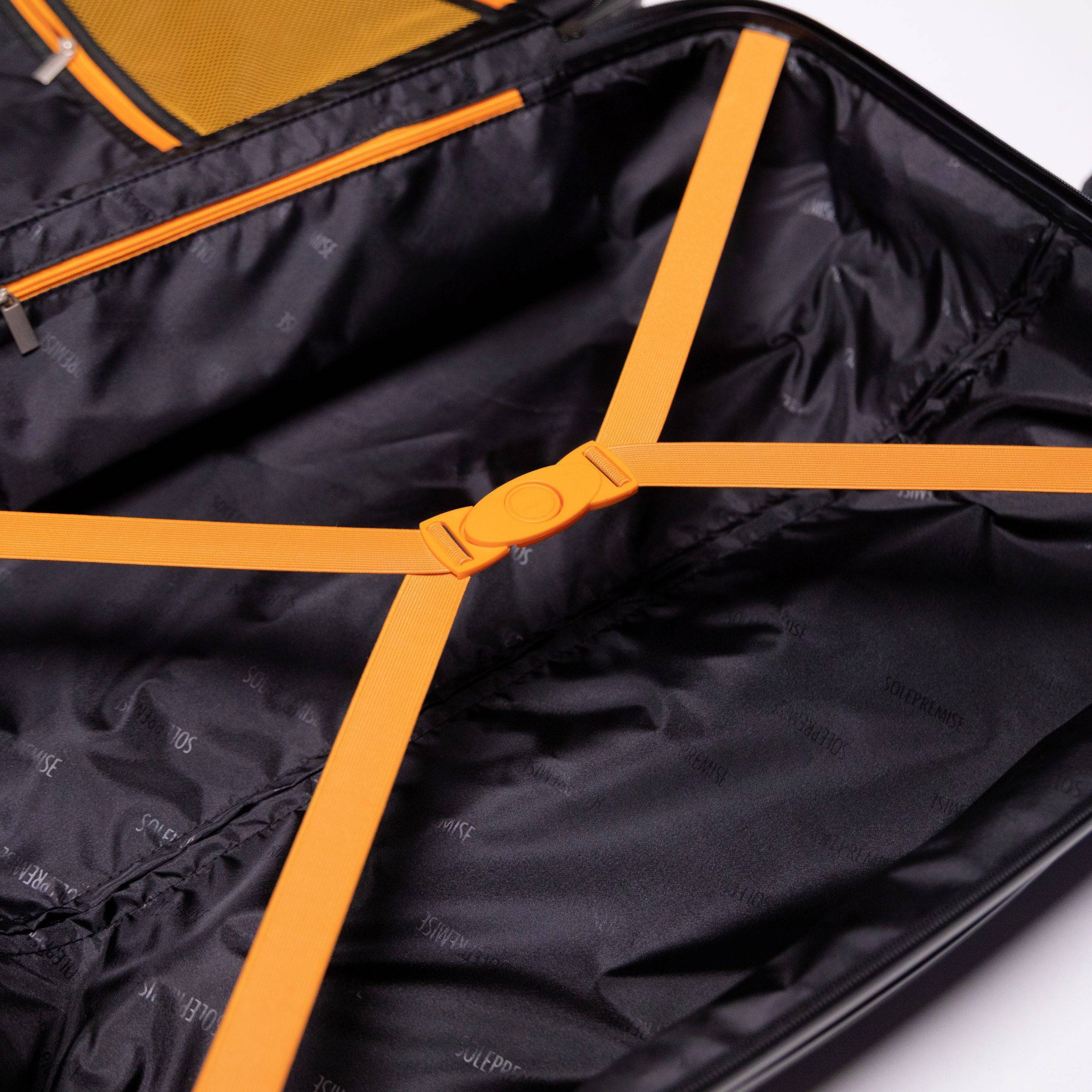 Black suitcase with orange straps on a white background