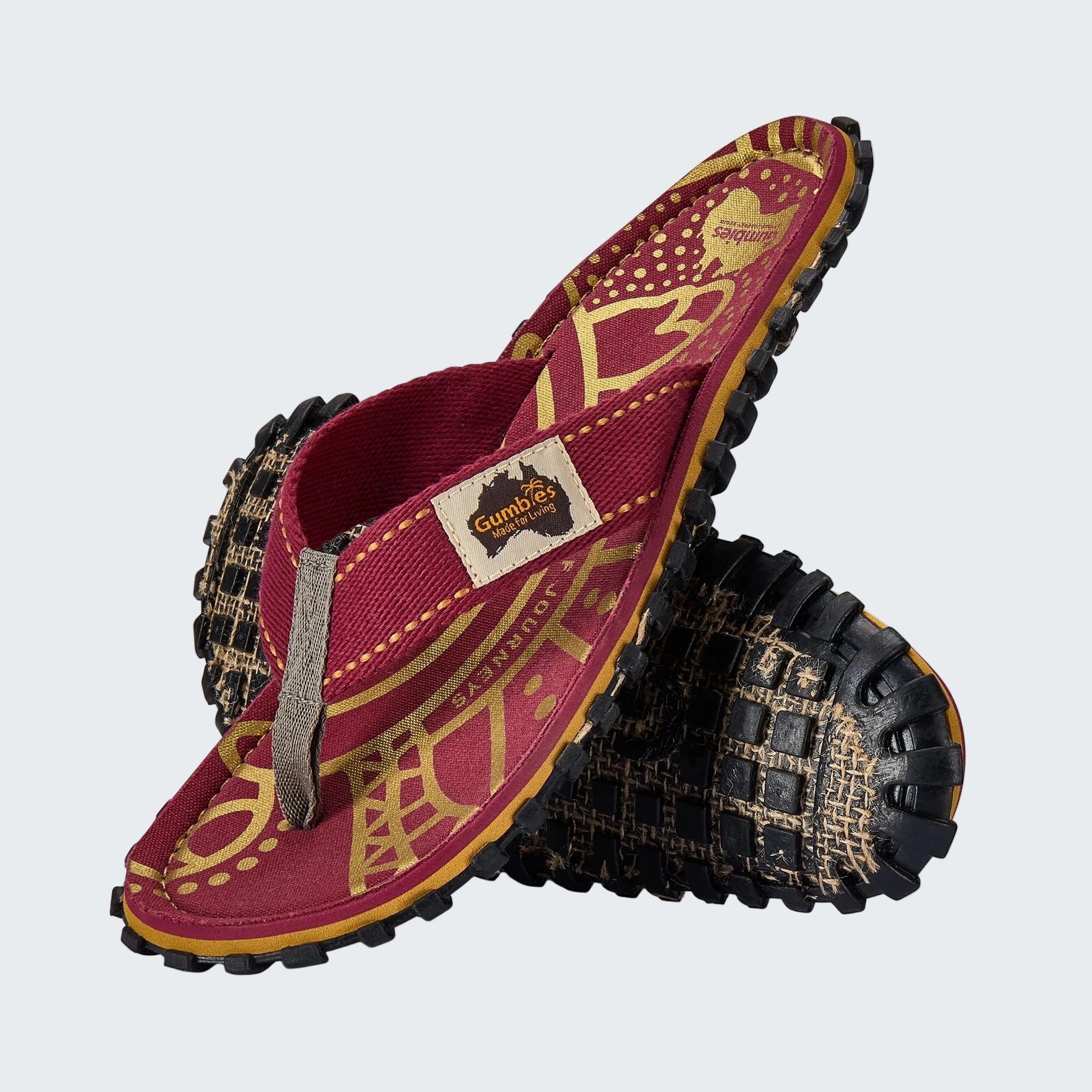 Red and gold sandal with black soles on a white background