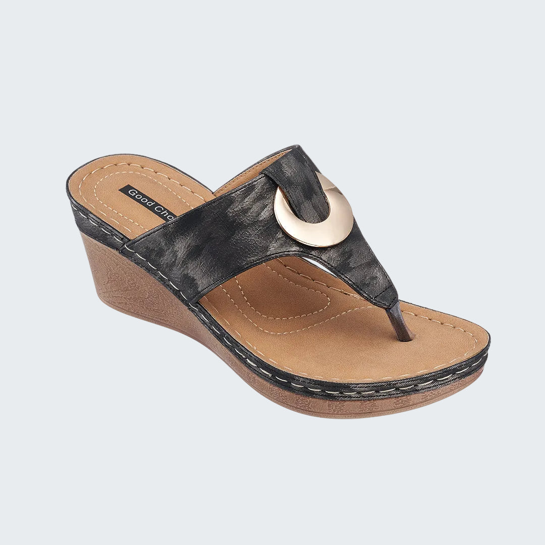 Black wedge sandal with tan insole on a white background