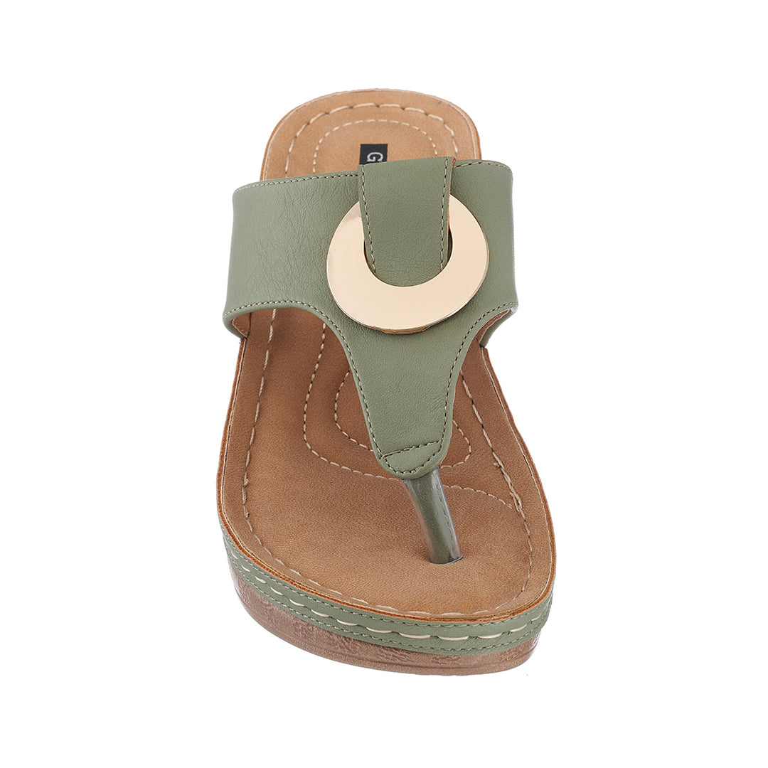 Green sandal with a circular design on a white background