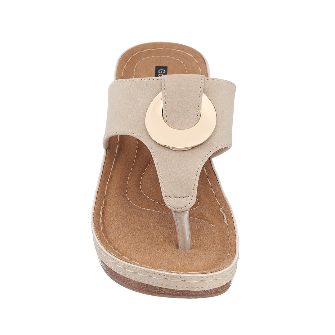 Beige sandal with a circular design on a white background