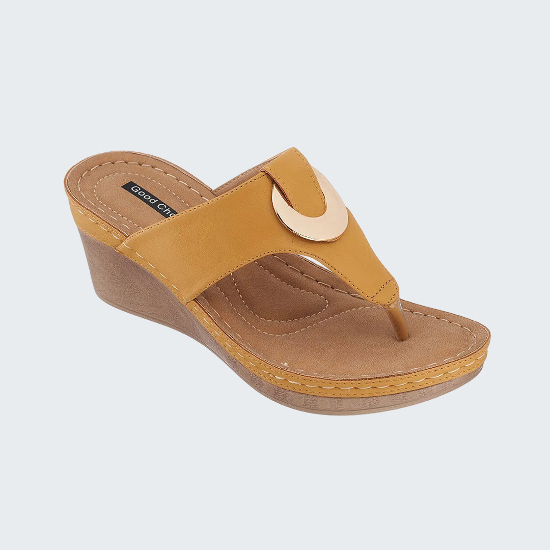Brown wedge sandal with a beige strap on a white background