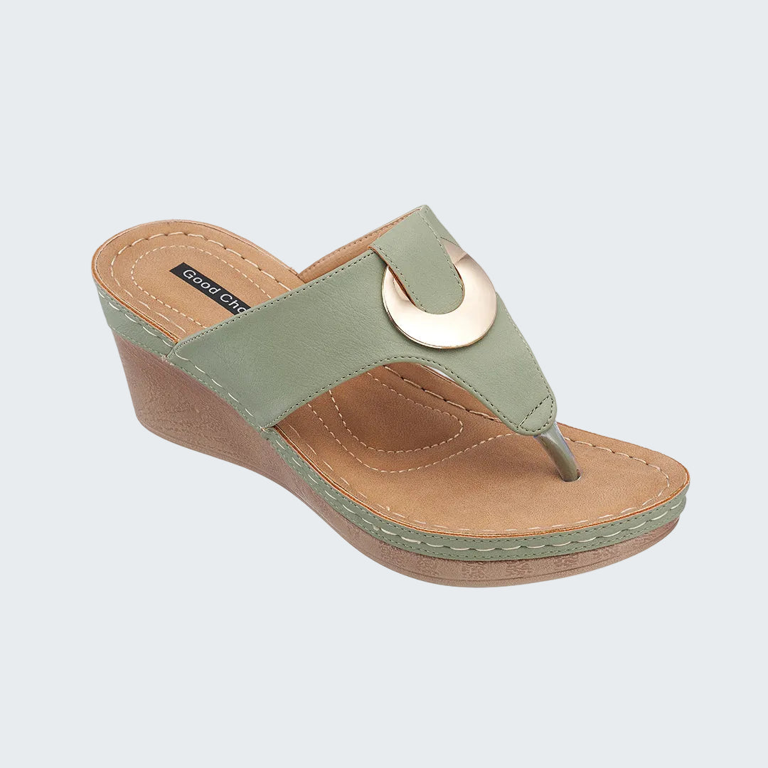 Green wedge sandal with a tan sole on a white background
