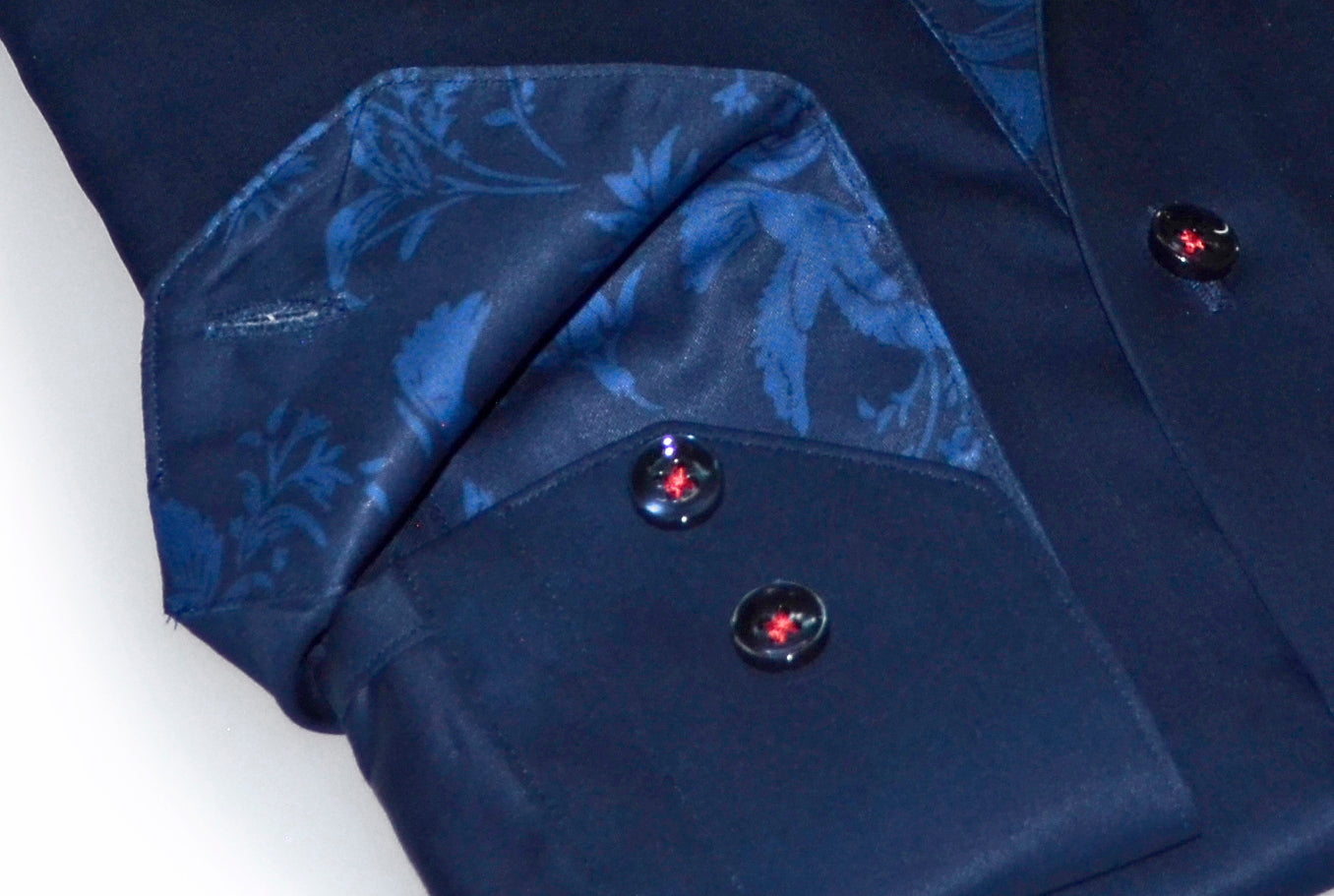 Close-up of a navy blue suit jacket with floral patterned lining and buttons.