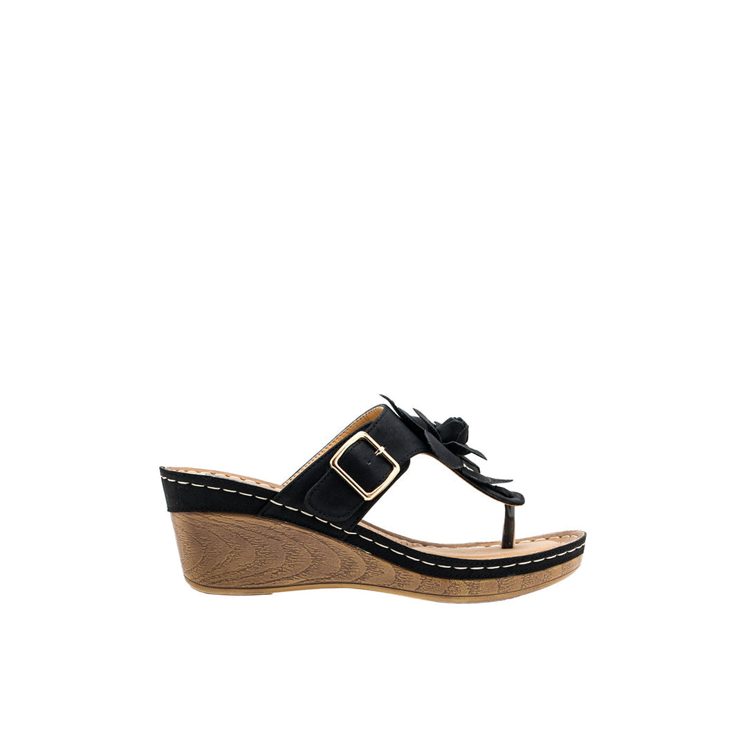 Black wedge sandal with a bow on a white background
