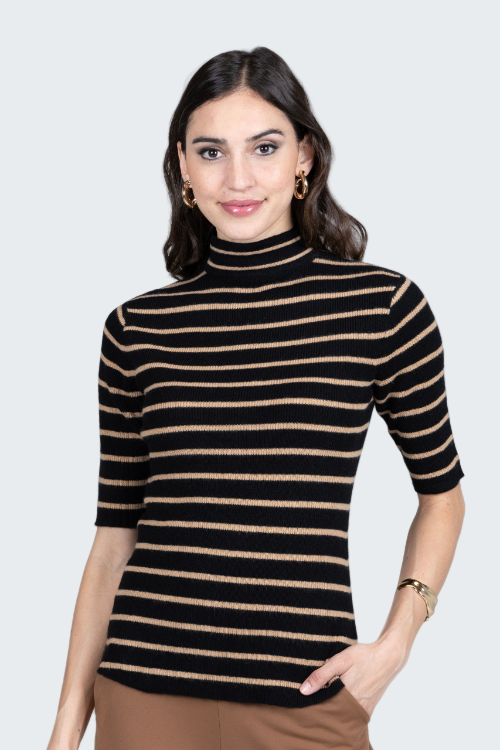 Woman wearing a black and beige striped turtleneck sweater on a gray background