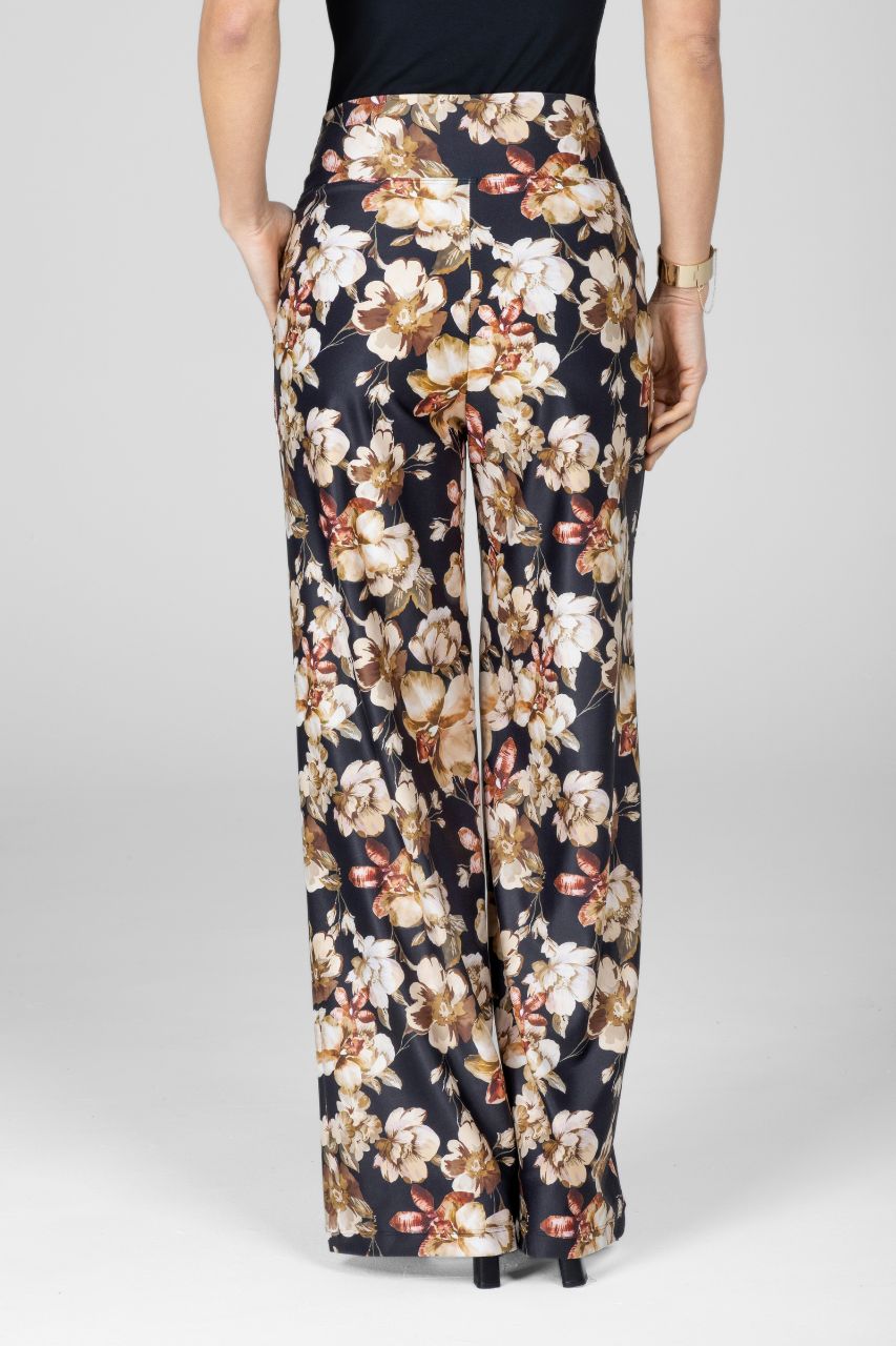 Floral patterned pants worn by a person on a white background