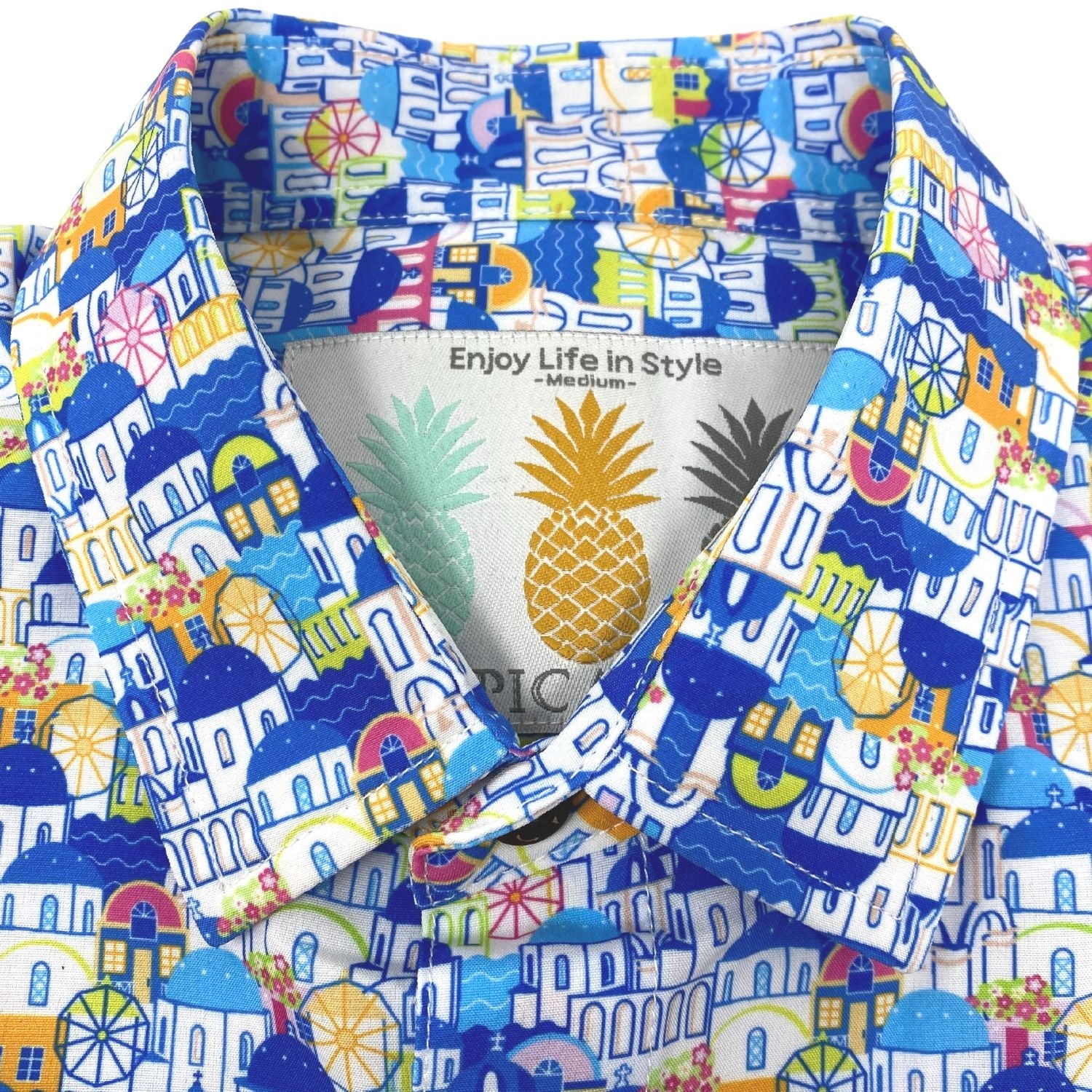 Colorful patterned shirt with a pineapple logo on the label