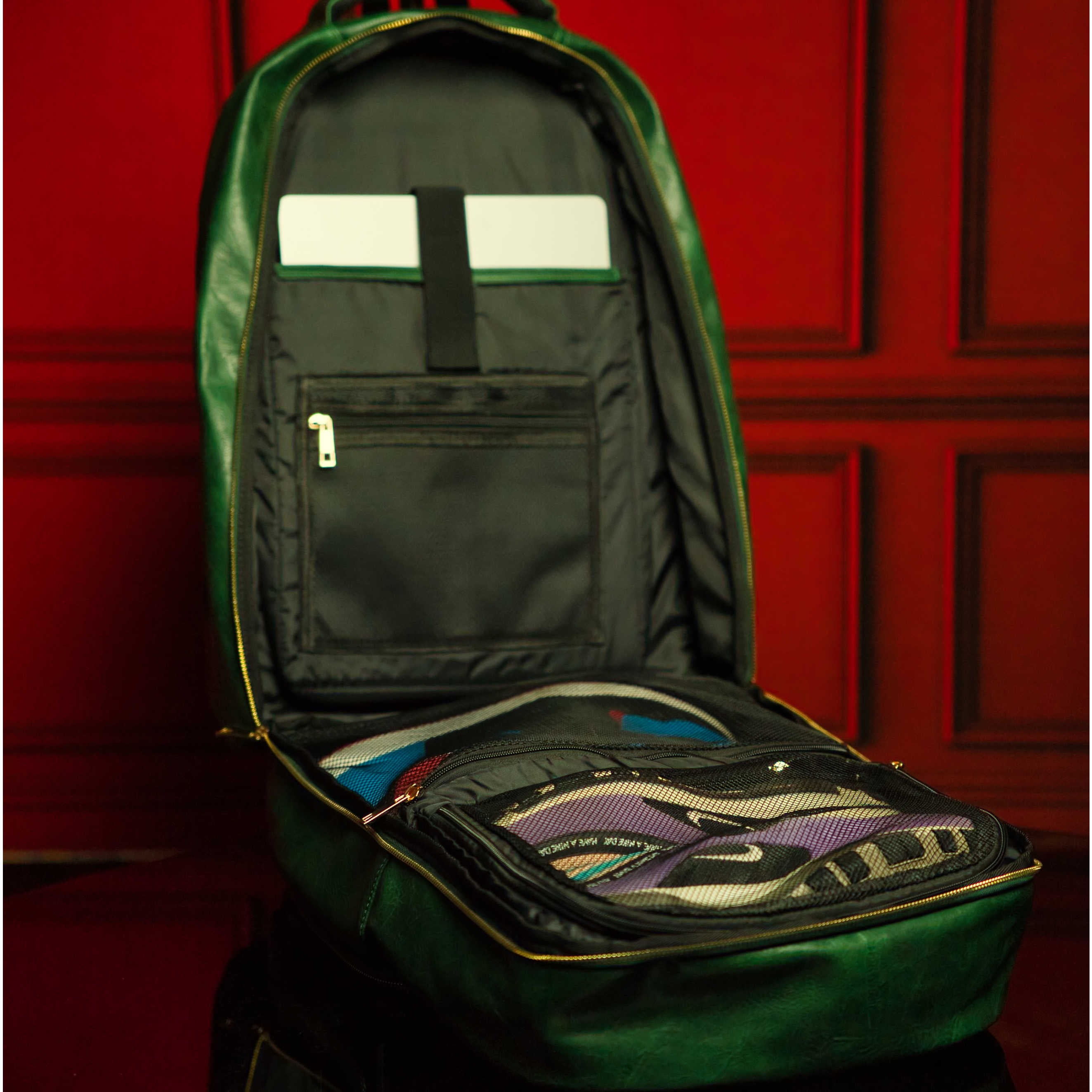 Green backpack with open front compartment against a red background