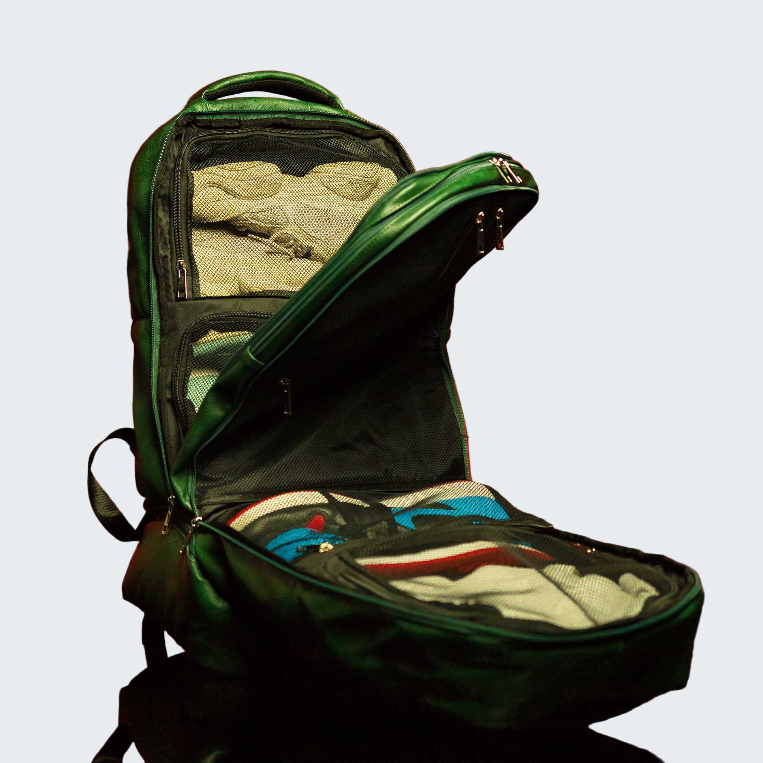 Green backpack with clothes on a red background