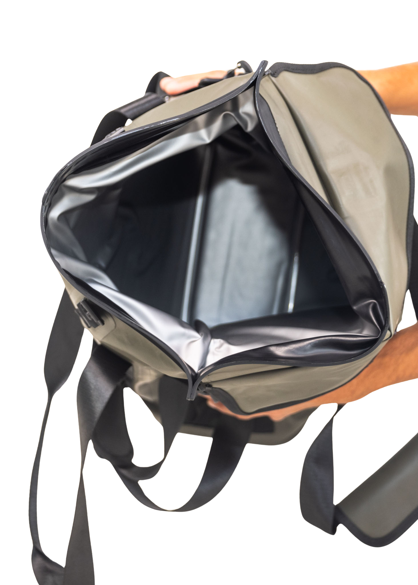 Backpack with a black interior pocket held open by a hand on a white background
