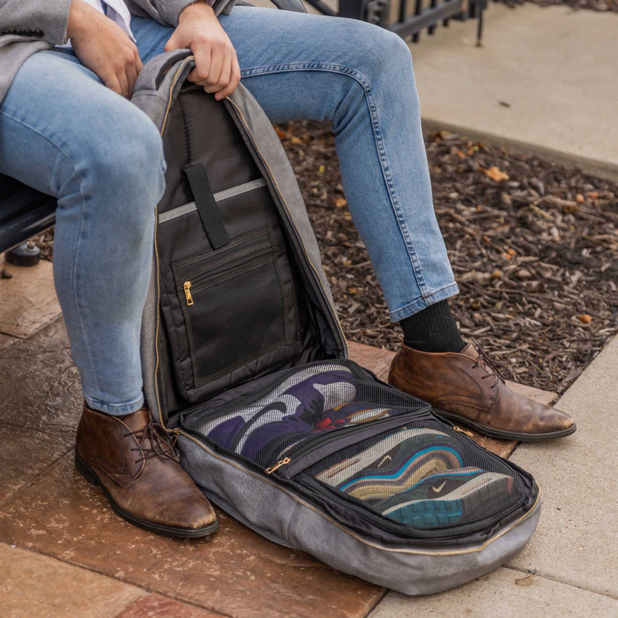 Person sitting on a bench with an open guitar case on the ground