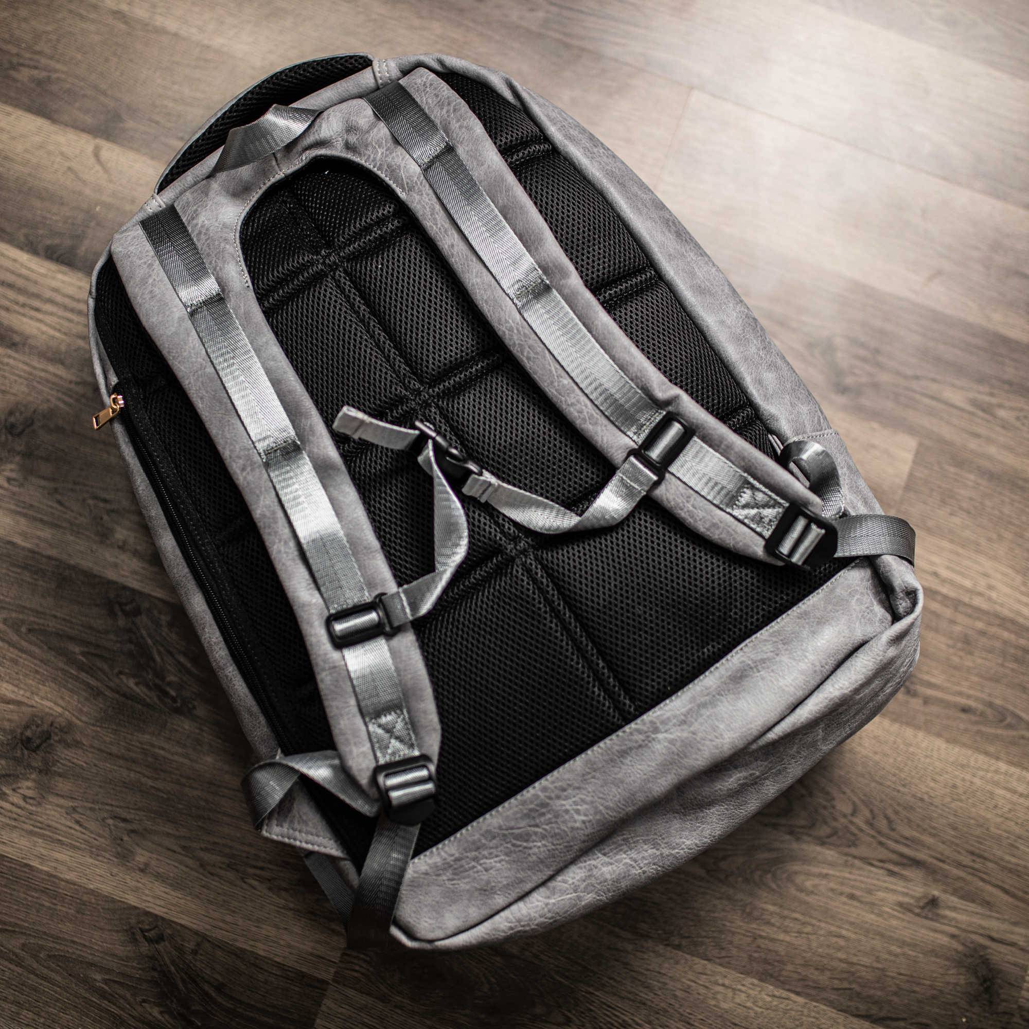 Gray and black backpack on a wooden surface